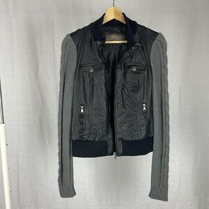 Ci Sono Women’s Black Faux Leather Jacket with knitted dark grey sleeves…